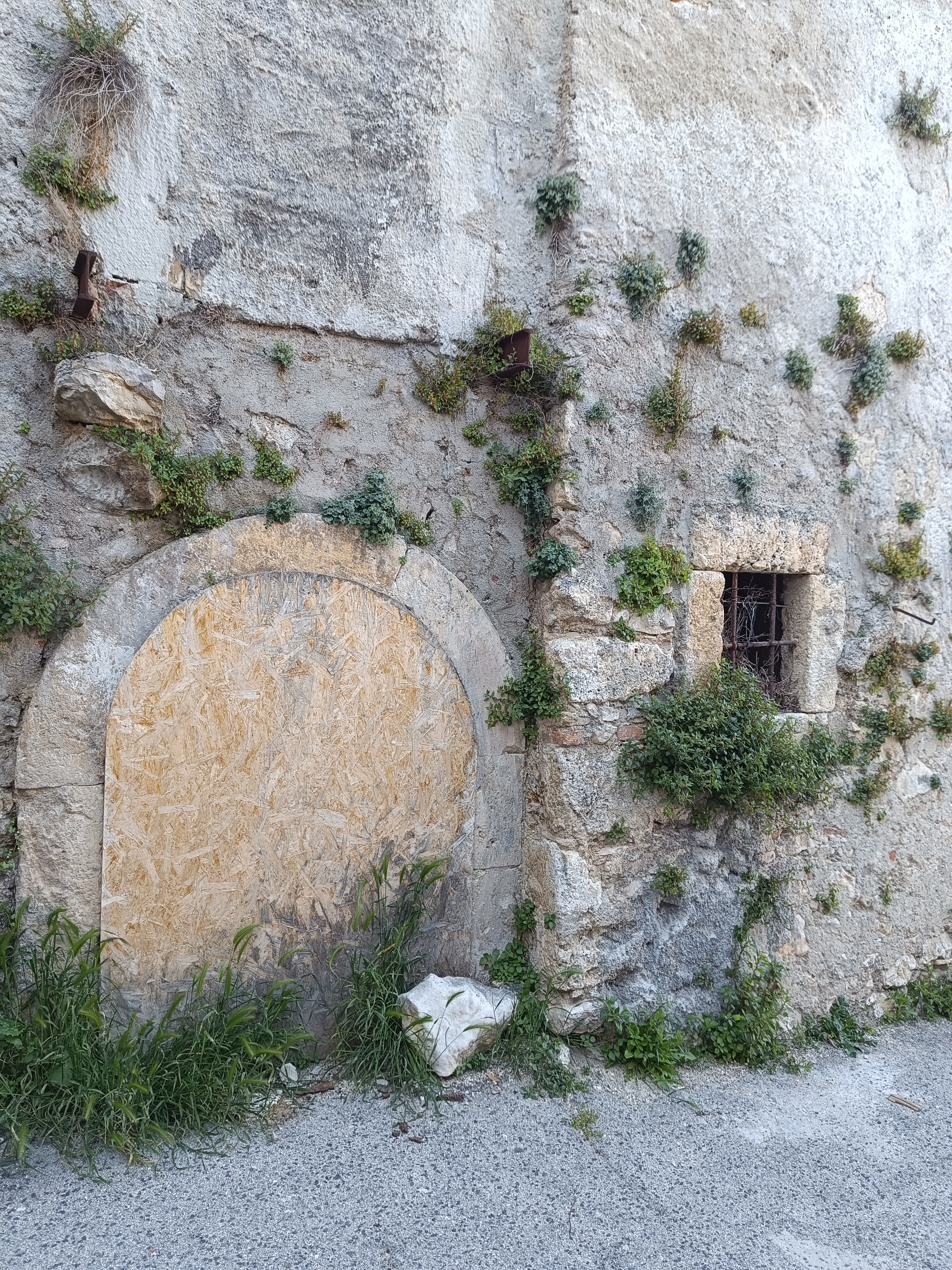 Old walled-up door of a house in Aielli