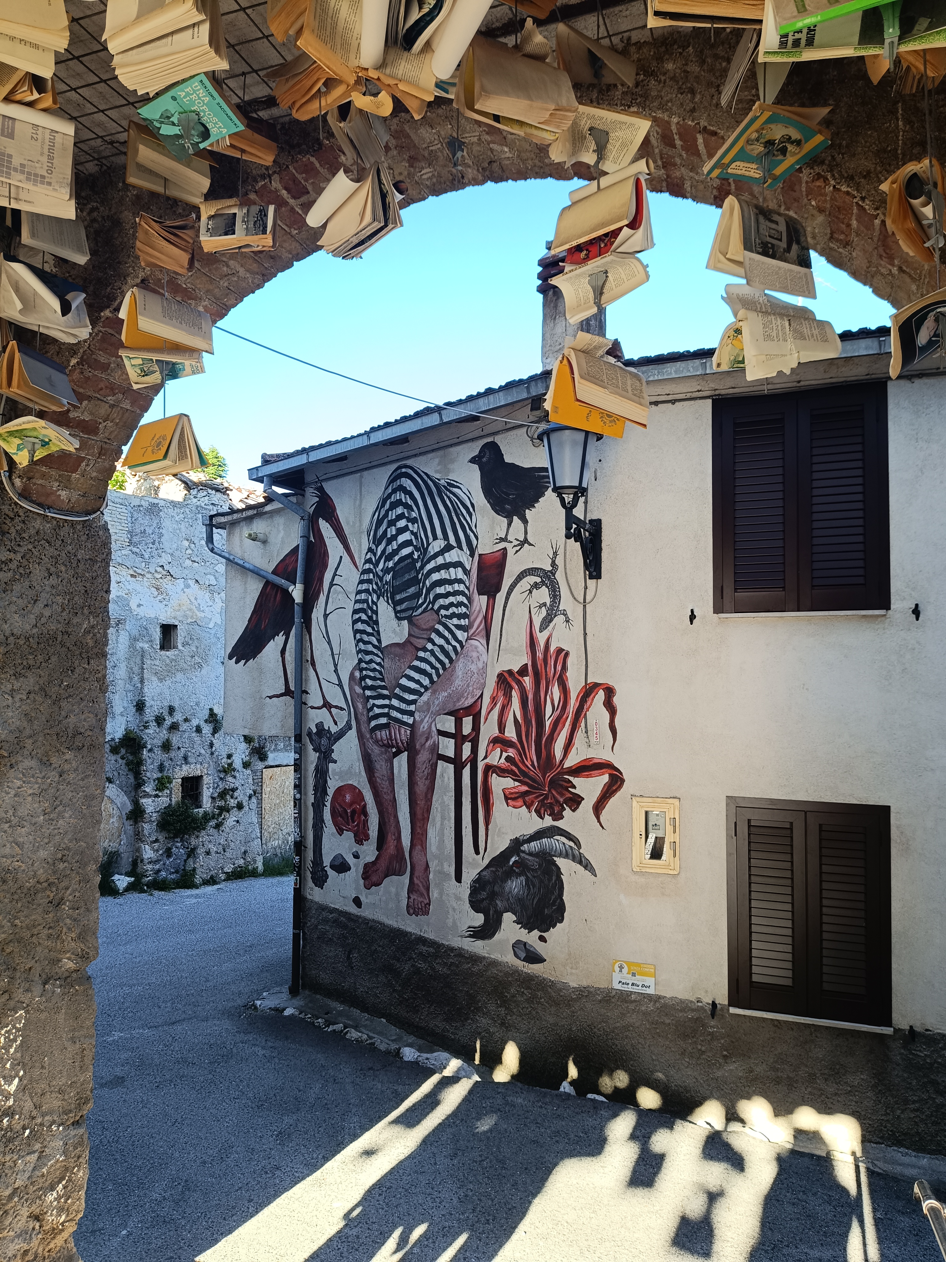 Gallery of hanging books in Aielli swaying in the wind