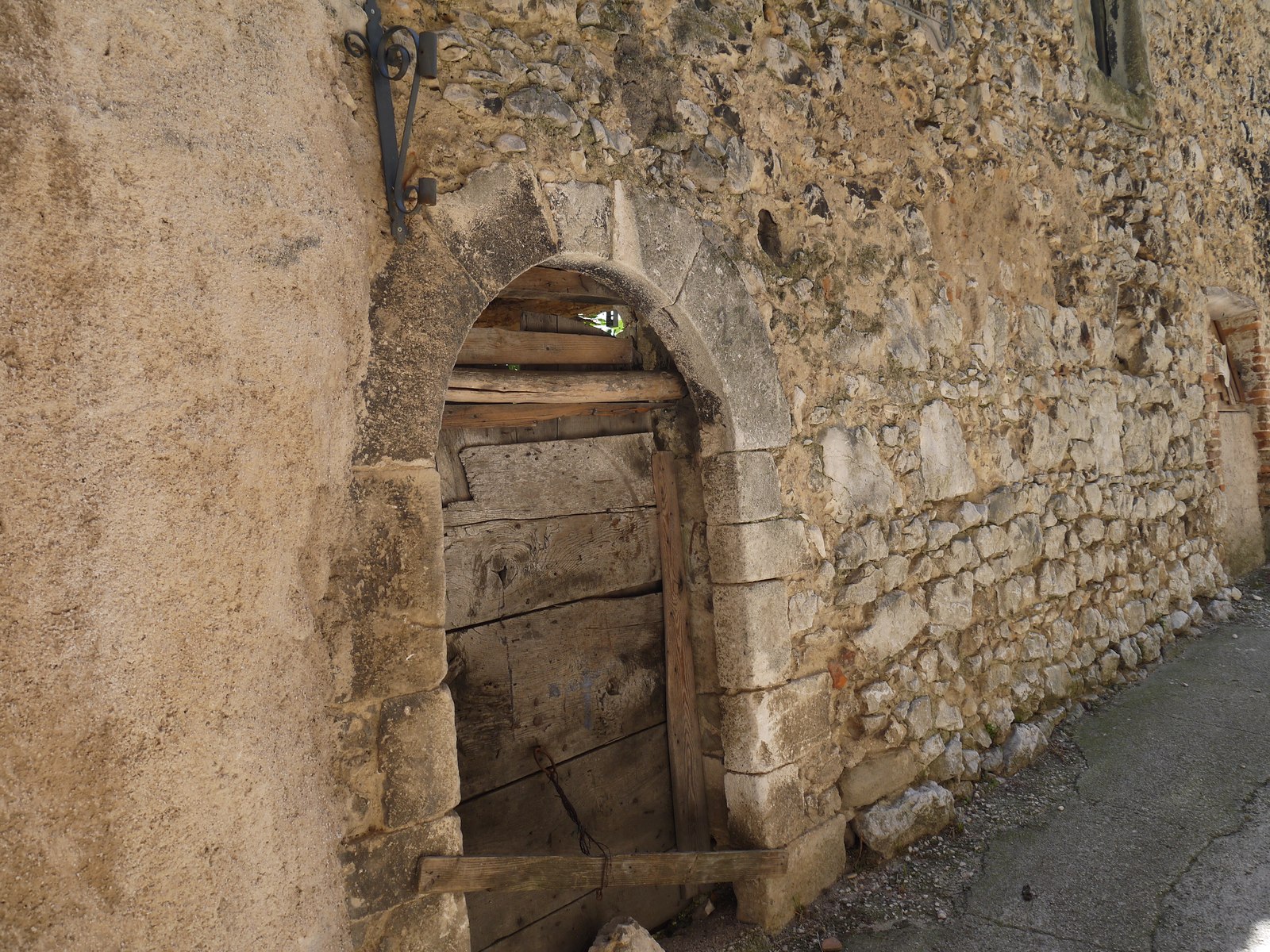 A weathered wooden door of what was once a stable